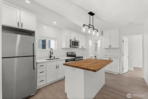 a kitchen with white cabinets and white appliances