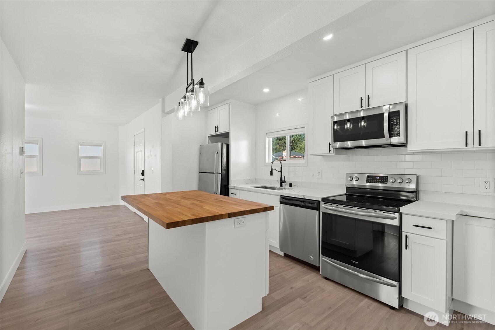 14915 Portland Avenue Southwest Lakewood, WA 98498 - Photo 7 of 29 a kitchen with stainless steel appliances granite countertop a stove a sink and a microwave