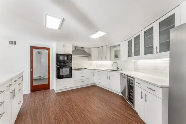 a kitchen with stainless steel appliances a stove top oven and a refrigerator