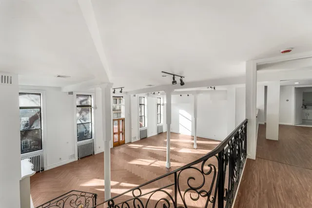 a dining room with furniture and wooden floor