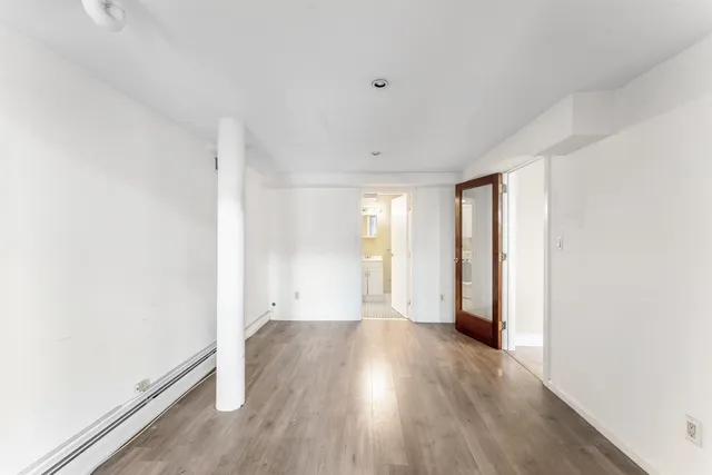 a view of room with window and wooden floor