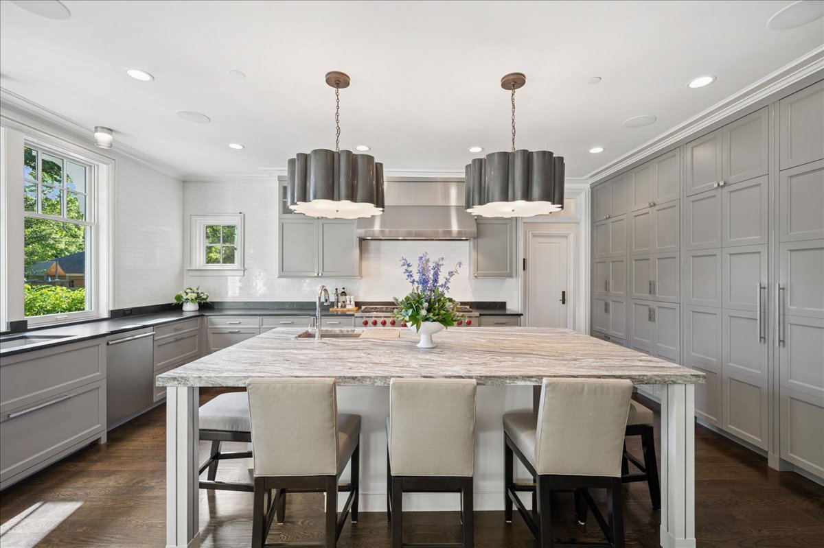 819 Chestnut Avenue Wilmette, IL 60091 - Photo 30 of 100 a kitchen with stainless steel appliances a dining table chairs and white cabinets