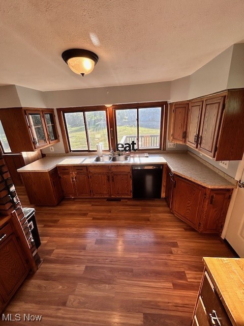 17510 Munn Road Chagrin Falls, OH 44023 - Photo 14 of 35 Kitchen with dark wood-style floors, black dishwasher, brown cabinets, and a sink