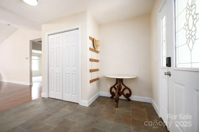 a view of a kitchen with wooden floor and a window