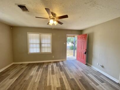 2805 37th Street Lubbock, TX 79413 - Photo 2 of 11 a view of empty room with wooden floor and fan