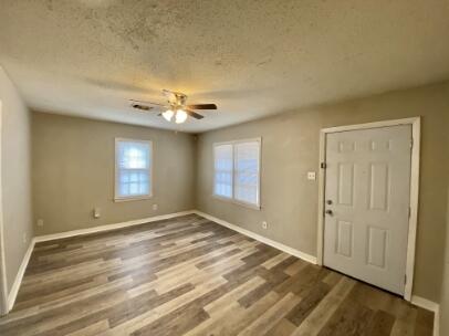 2805 37th Street Lubbock, TX 79413 - Photo 3 of 11 a view of an empty room with window and hardwood floor