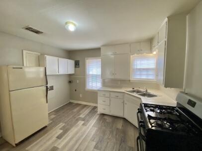 2805 37th Street Lubbock, TX 79413 - Photo 5 of 11 a kitchen with a sink stove and refrigerator