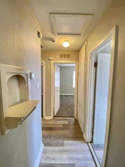2805 37th Street Lubbock, TX 79413 - Photo 6 of 11 a view of a hallway view with wooden floor and staircase