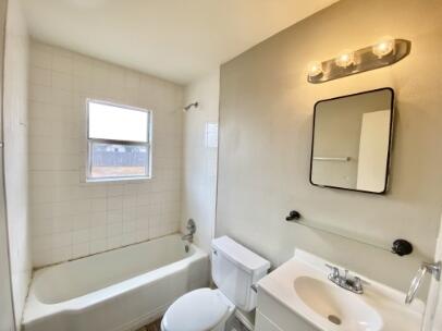 2805 37th Street Lubbock, TX 79413 - Photo 7 of 11 a bathroom with a toilet sink and bathtub