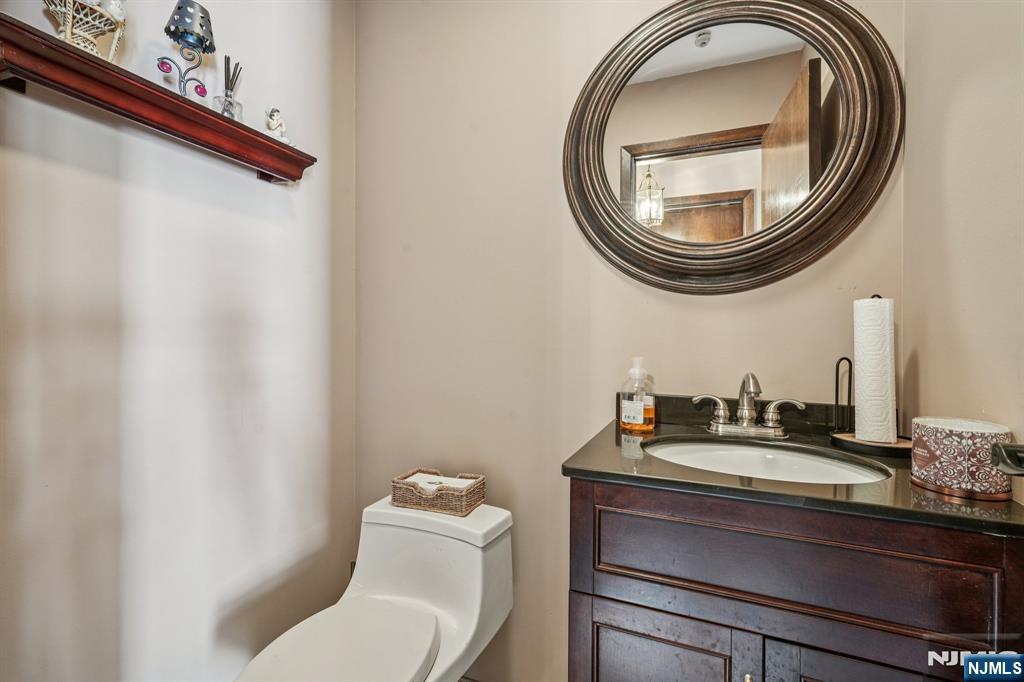 845 Rifle Camp Road Woodland Park, NJ 07424 - Photo 25 of 50 a bathroom with a toilet and a mirror
