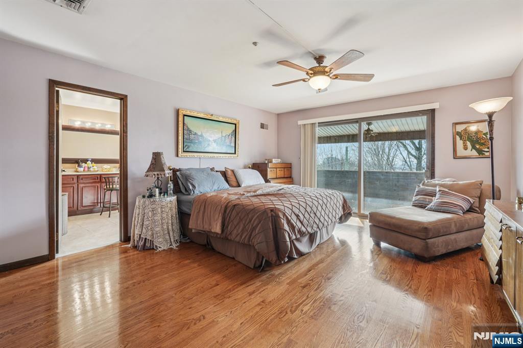 845 Rifle Camp Road Woodland Park, NJ 07424 - Photo 29 of 50 a spacious bedroom with a bed a couch and a large window