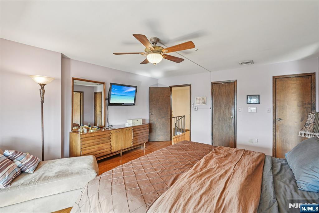 845 Rifle Camp Road Woodland Park, NJ 07424 - Photo 30 of 50 a bedroom with a bed and a chandelier