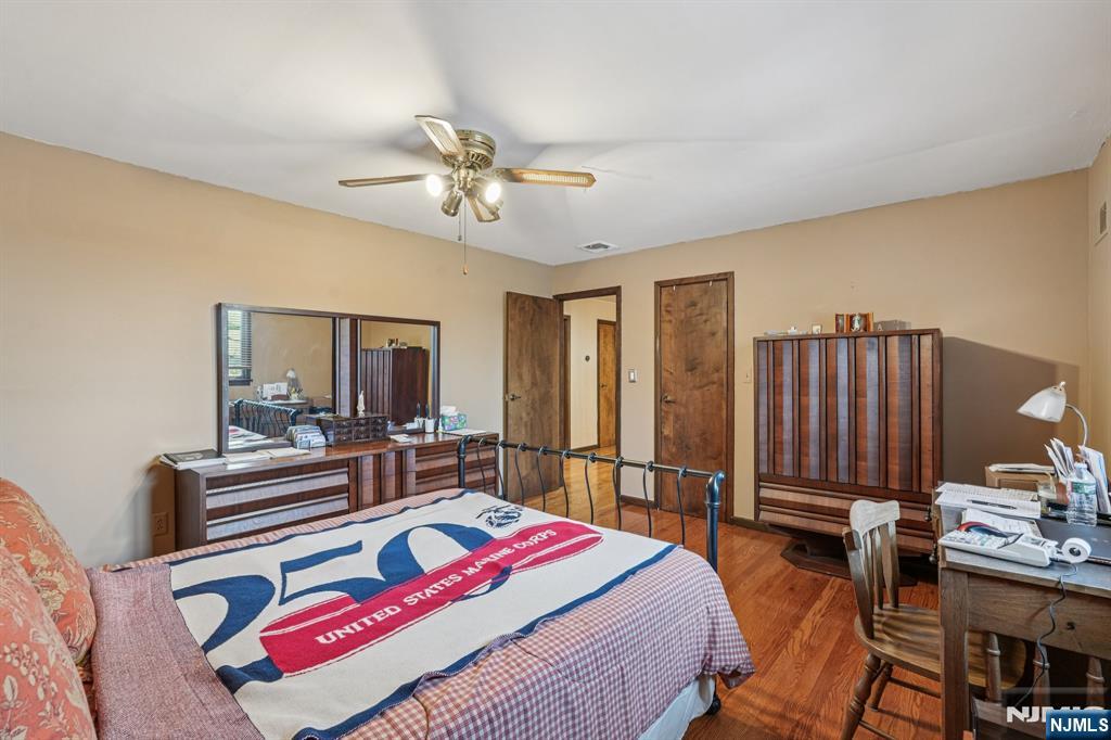 845 Rifle Camp Road Woodland Park, NJ 07424 - Photo 36 of 50 a bedroom with a bed a mirror and furniture