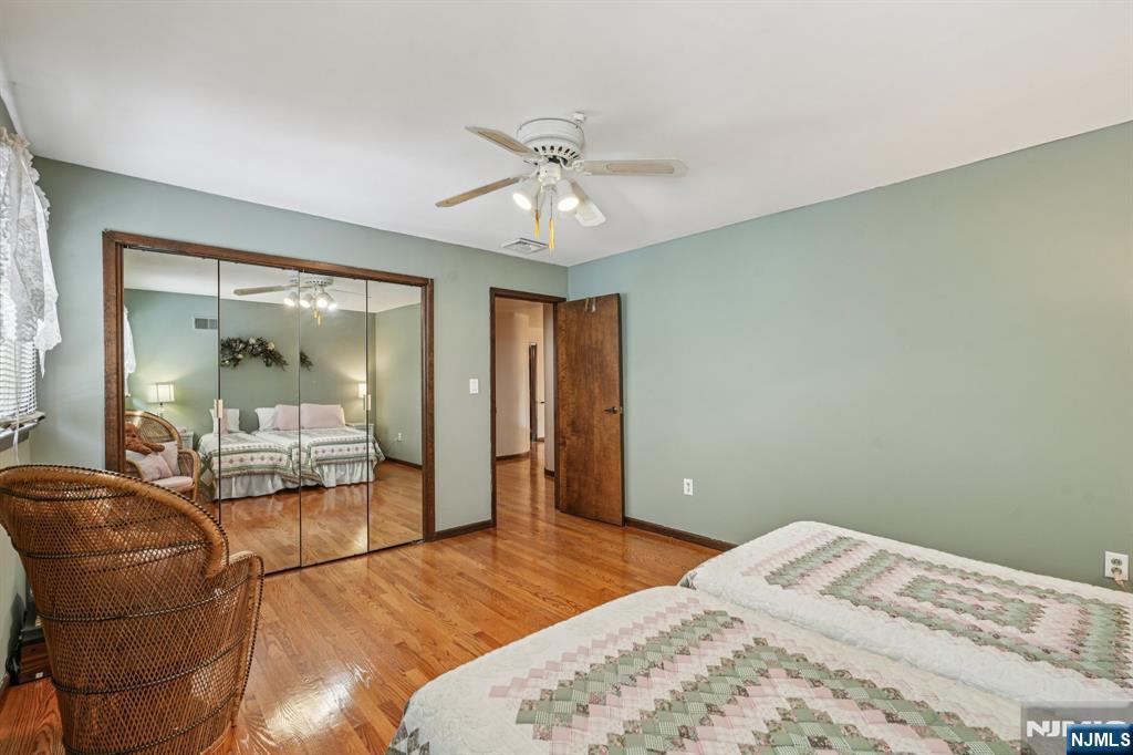 845 Rifle Camp Road Woodland Park, NJ 07424 - Photo 38 of 50 a bedroom with a bed couch and window