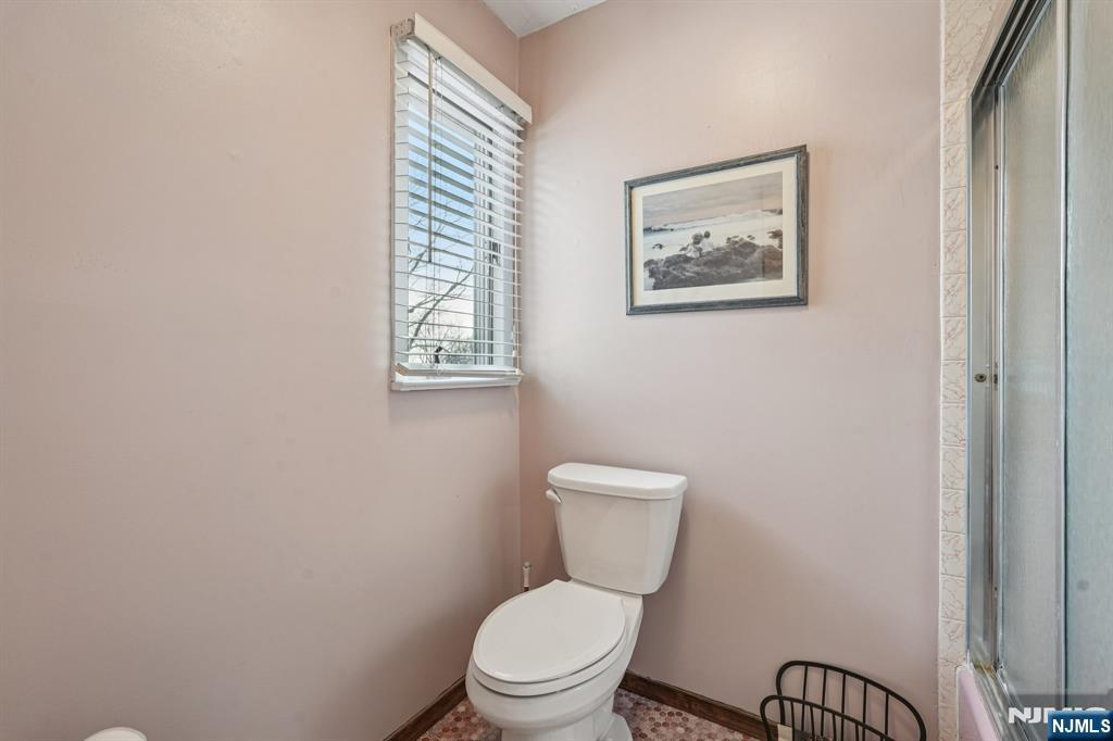 845 Rifle Camp Road Woodland Park, NJ 07424 - Photo 40 of 50 a white toilet sitting next to a bathroom sink