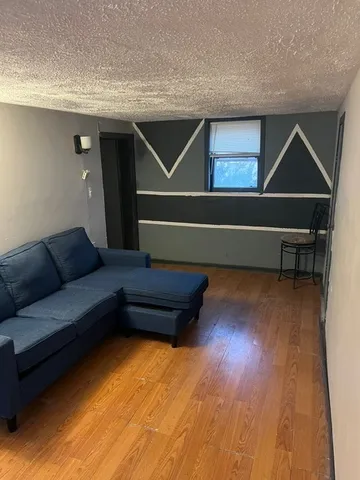 a living room with wooden floor and furniture