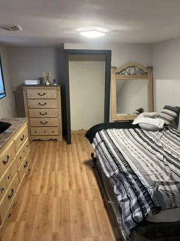 a bedroom with a bed and a dresser