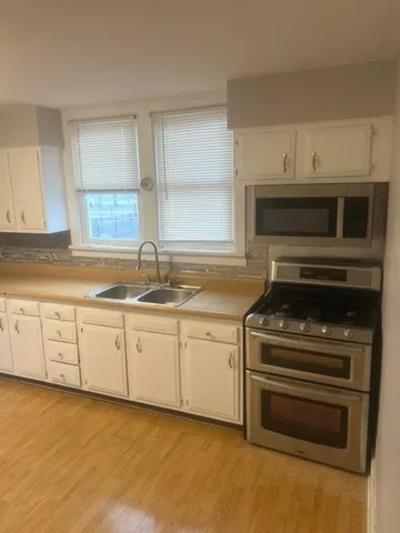 a kitchen with granite countertop a stove and a sink