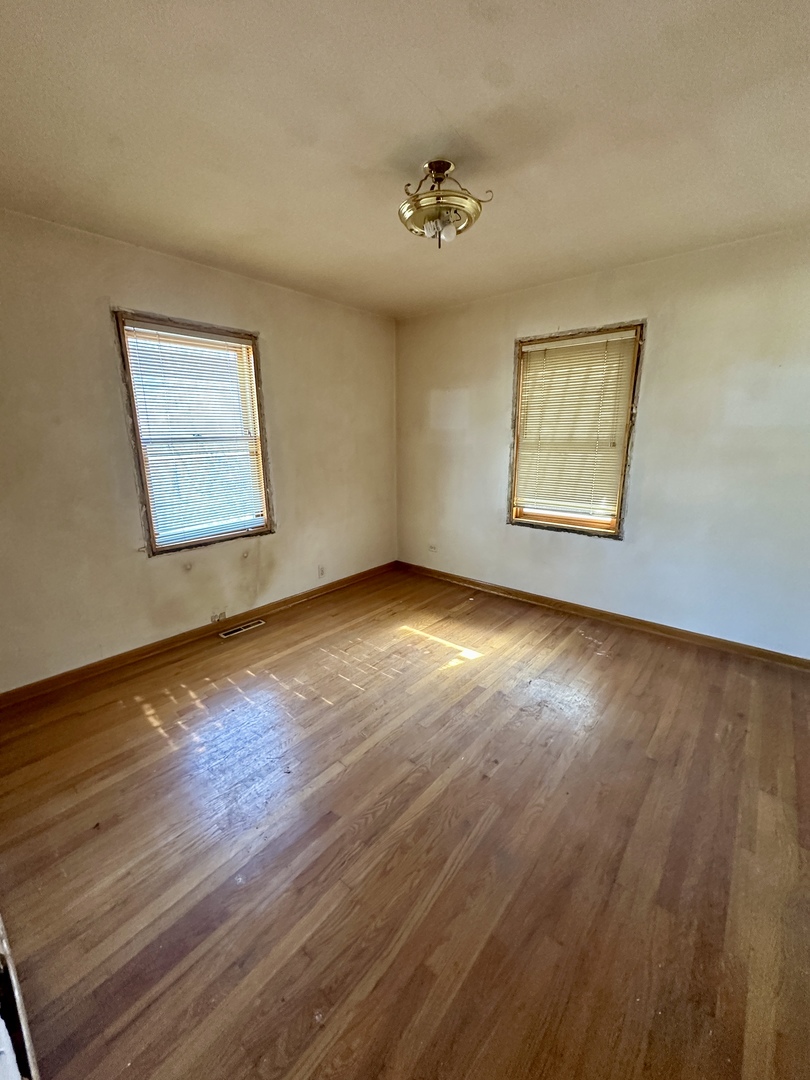 215 North Main Street Mount Prospect, IL 60056 - Photo 11 of 17 a view of an empty room with wooden floor and a window