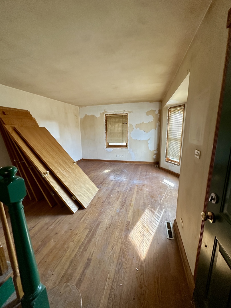 215 North Main Street Mount Prospect, IL 60056 - Photo 14 of 17 a view of an empty room with wooden floor and a window
