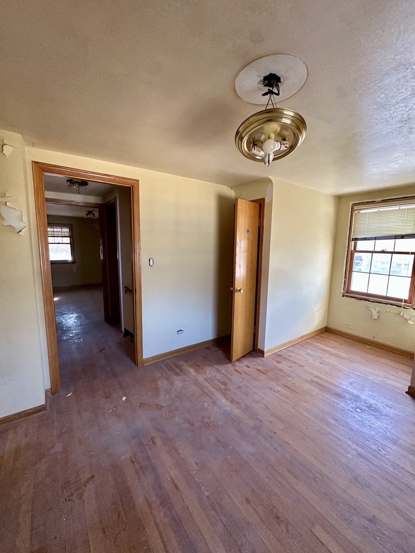 215 North Main Street Mount Prospect, IL 60056 - Photo 3 of 17 an empty room with wooden floor closet and windows