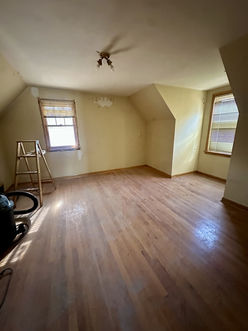 215 North Main Street Mount Prospect, IL 60056 - Photo 5 of 17 a view of a room with wooden floor staircase and windows