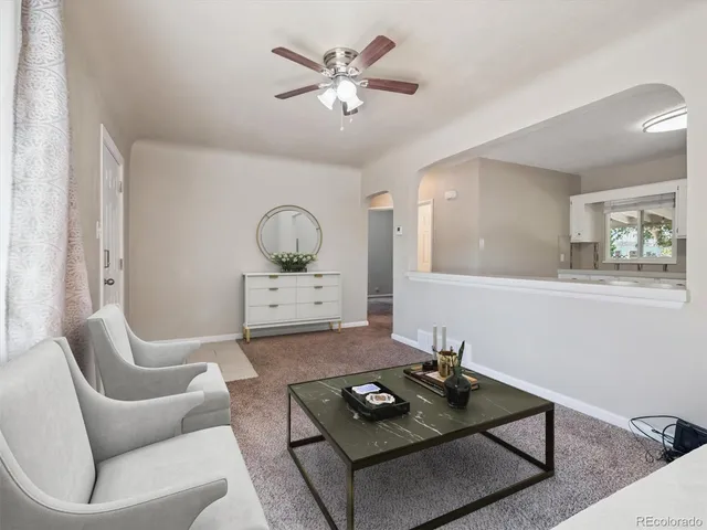 a living room with furniture and a table