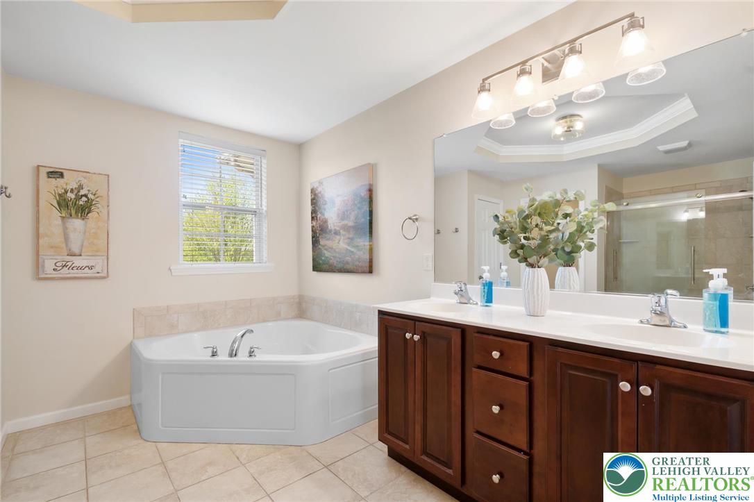 208 East Dell Road Bath, PA 18014 - Photo 23 of 40 a spacious bathroom with a tub sink and mirror