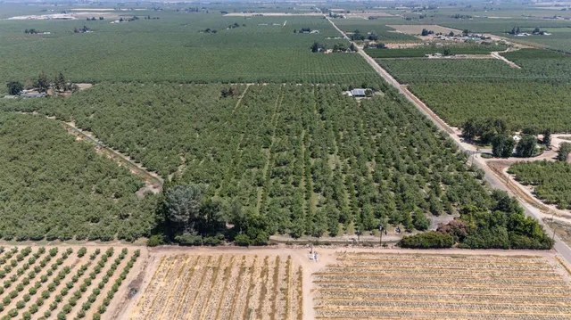 an aerial view of a houses with a yard