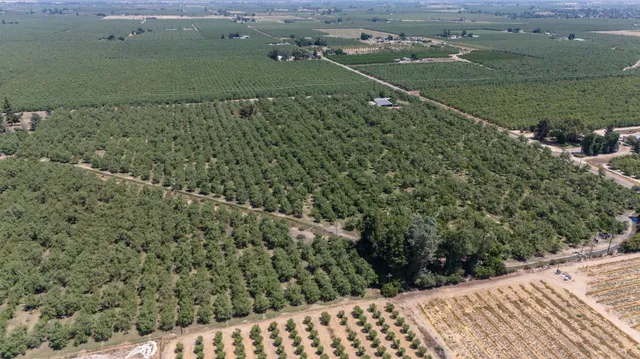 an aerial view of a houses with a yard