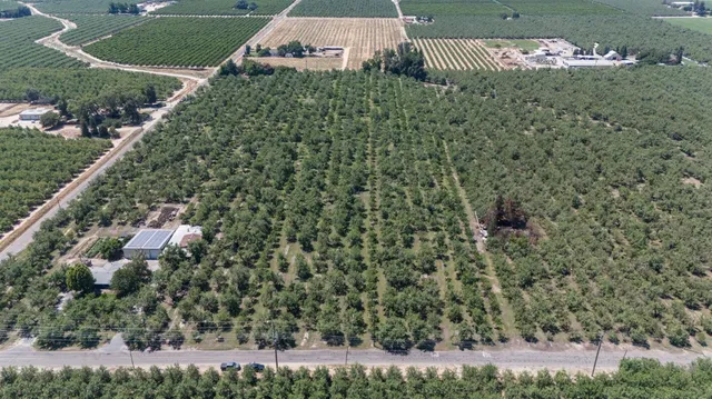 a aerial view of a house with a yard and street