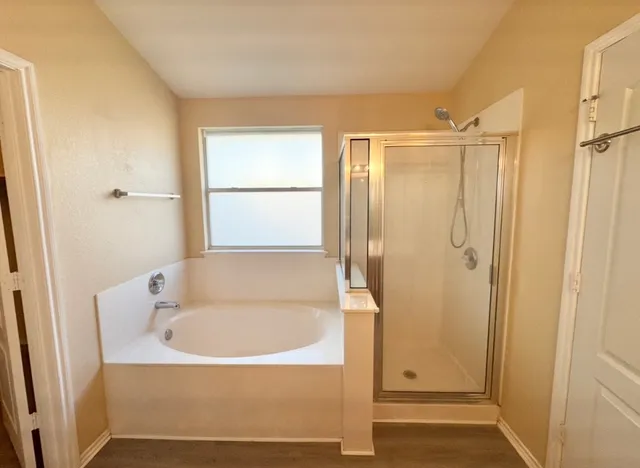 a bathroom with a tub and a shower