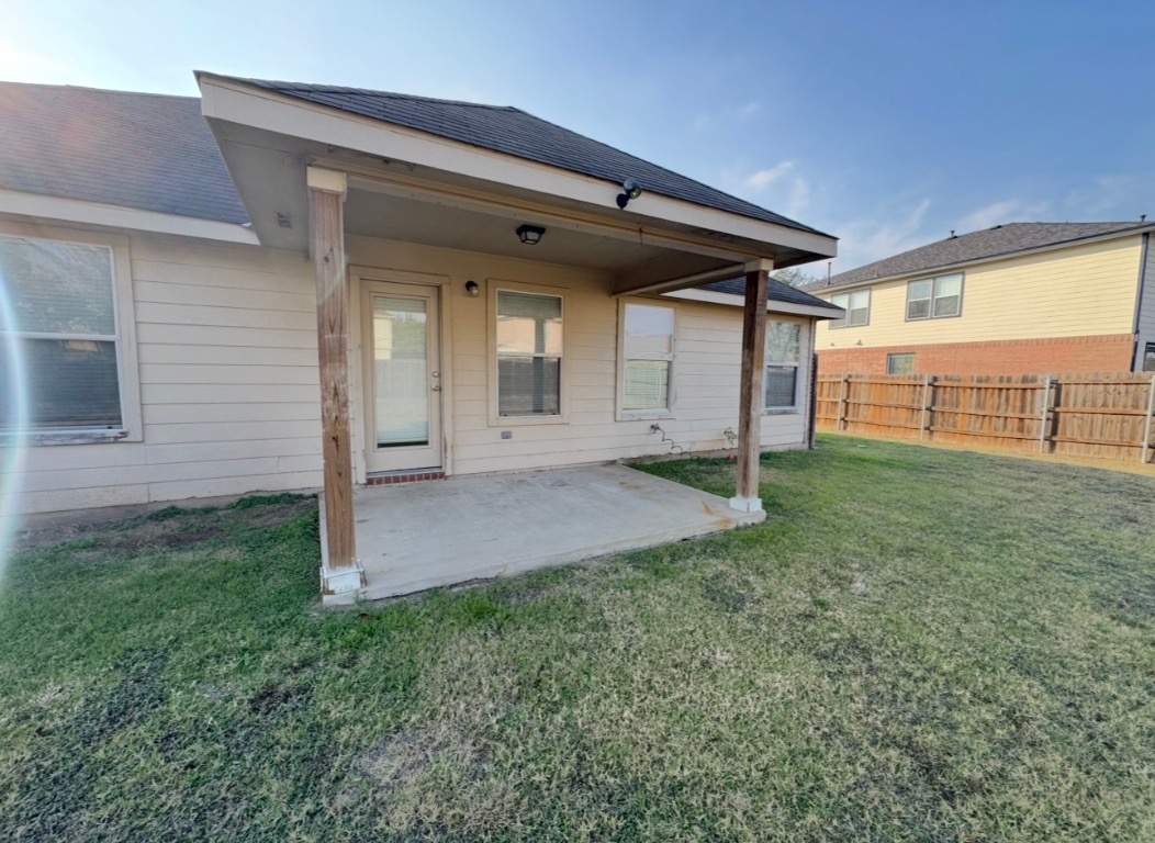 12809 Wood Lily Trail Elgin, TX 78621 - Photo 24 of 26 Back of house with a patio area and a fenced backyard