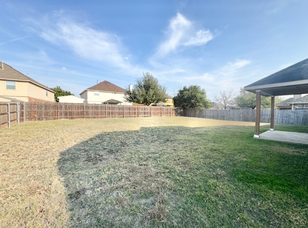 12809 Wood Lily Trail Elgin, TX 78621 - Photo 25 of 26 Fenced backyard with a patio