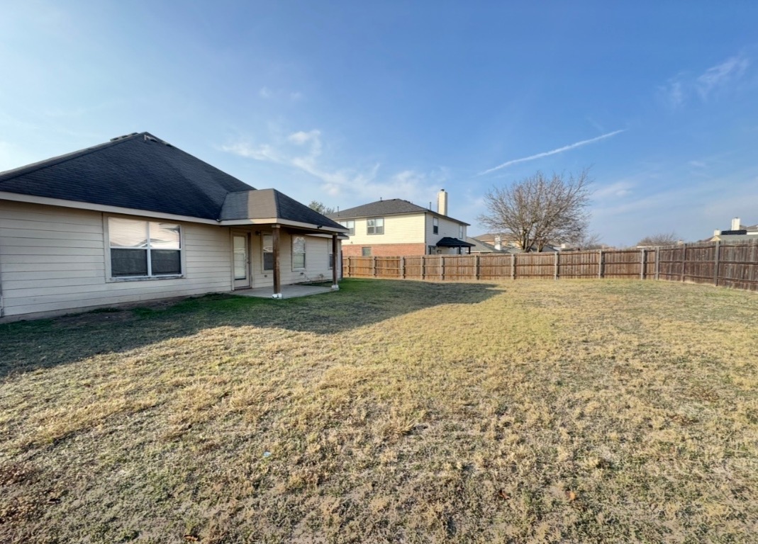 12809 Wood Lily Trail Elgin, TX 78621 - Photo 26 of 26 Fenced backyard with a patio area