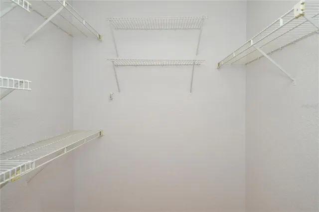 a kitchen with granite countertop a stove a sink a counter top space and cabinets