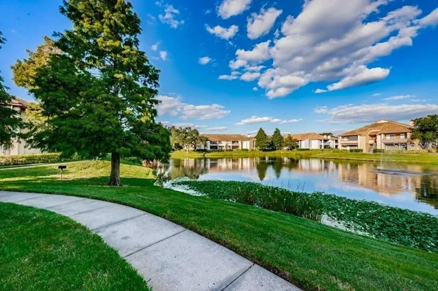 a view of a patio with a table and chairs under an umbrella