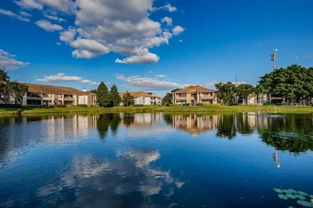 a view of a lake with houses in the background