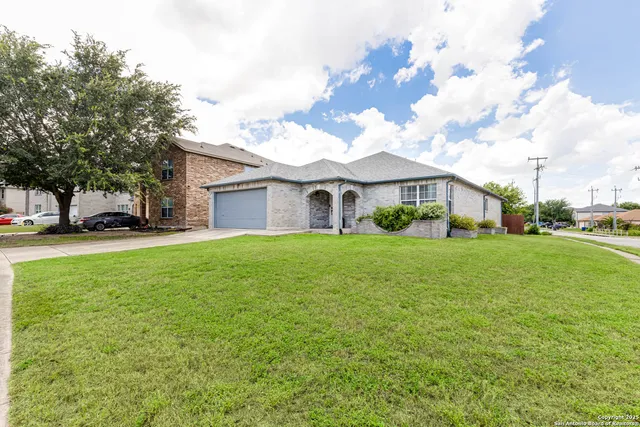 a front view of house with yard and green space