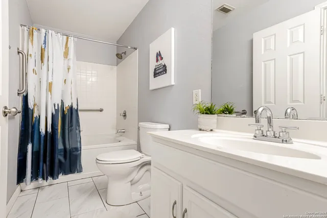 a bathroom with a granite countertop sink toilet and a shower