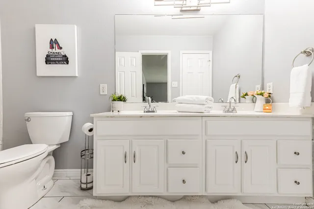 a bathroom with a toilet sink and mirror