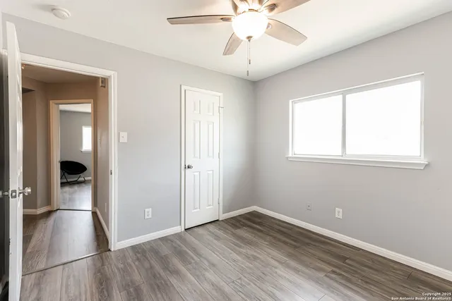 wooden floor in an empty room with a window
