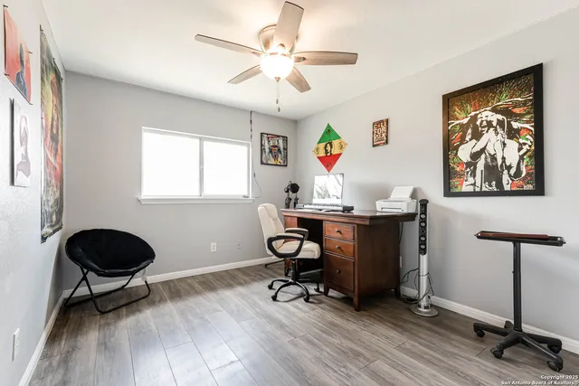 a view of a workspace with furniture and a window