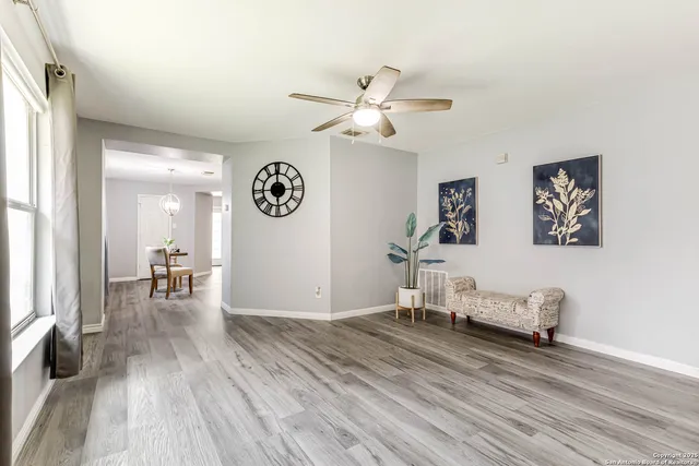 a bedroom with furniture and wooden floor