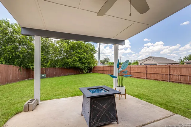 a view of a chair and table in the garden