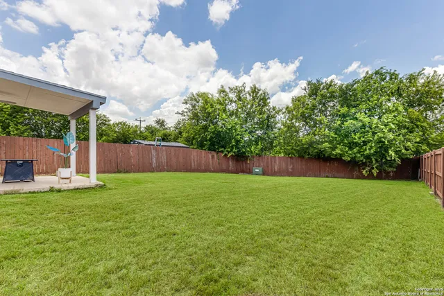 a backyard of a house with lots of green space
