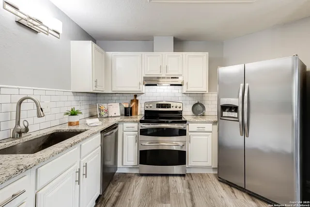 a kitchen with a refrigerator stove and sink