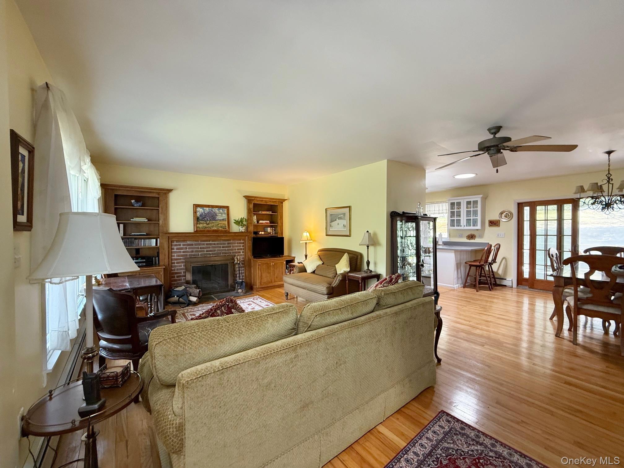 230 Cooper Road Millerton, NY 12546 - Photo 6 of 20 a living room with furniture a wooden floor and a flat screen tv