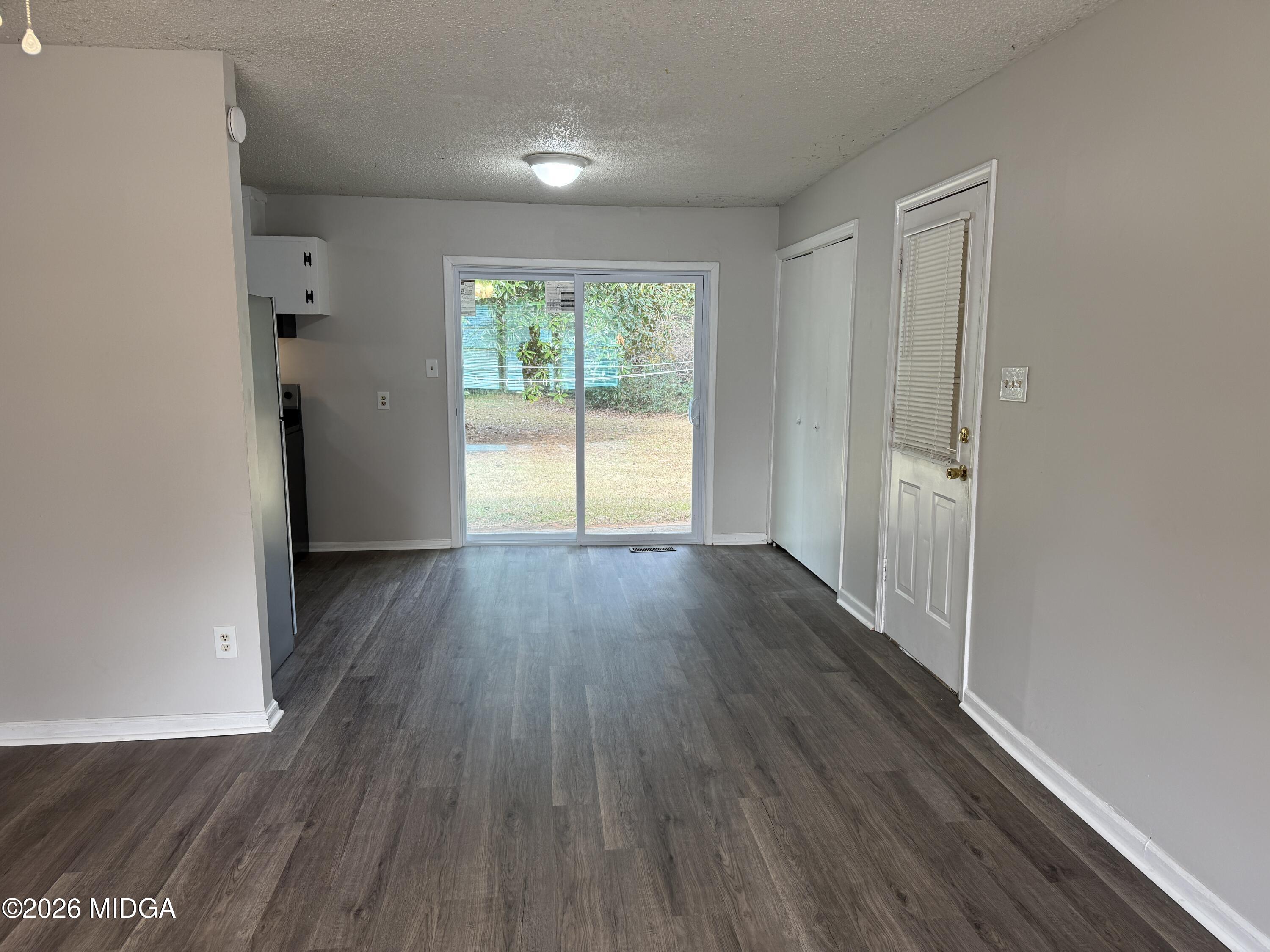 107 Miller Court Centerville, GA 31028 - Photo 4 of 16 wooden floor in an empty room with a window