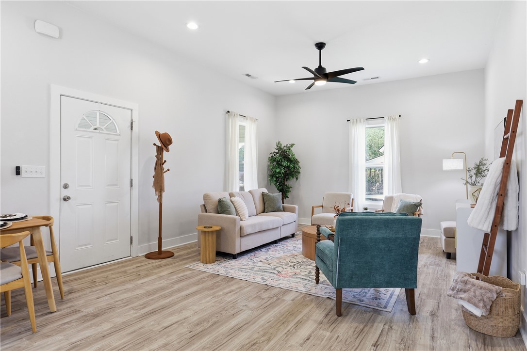 1 Brock Street Pelzer, SC 29669 - Photo 6 of 25 An inviting open-concept living area boasts light wood flooring and well-lit interiors.
